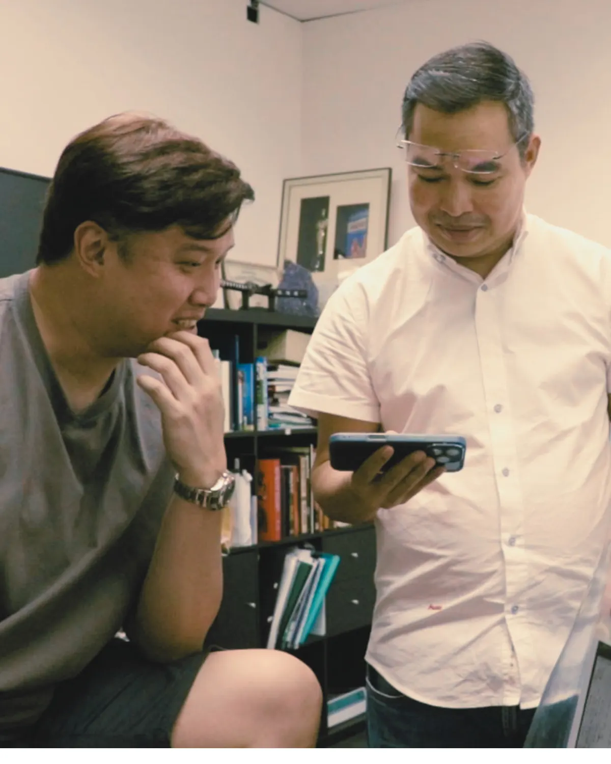Thanapark walking a client through findings on his phone during a consultation